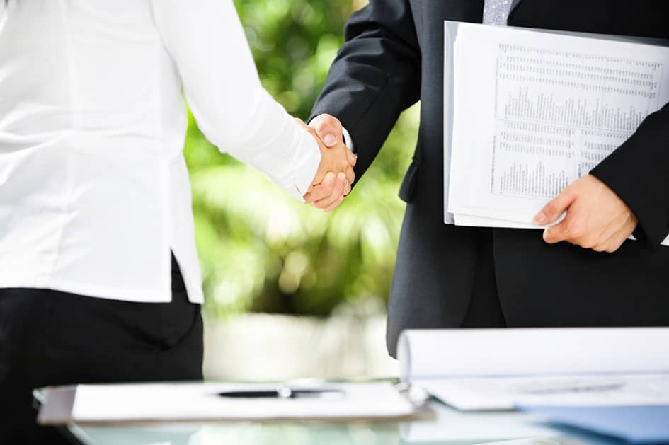 Handshake between businessman and businesswoman in a meeting